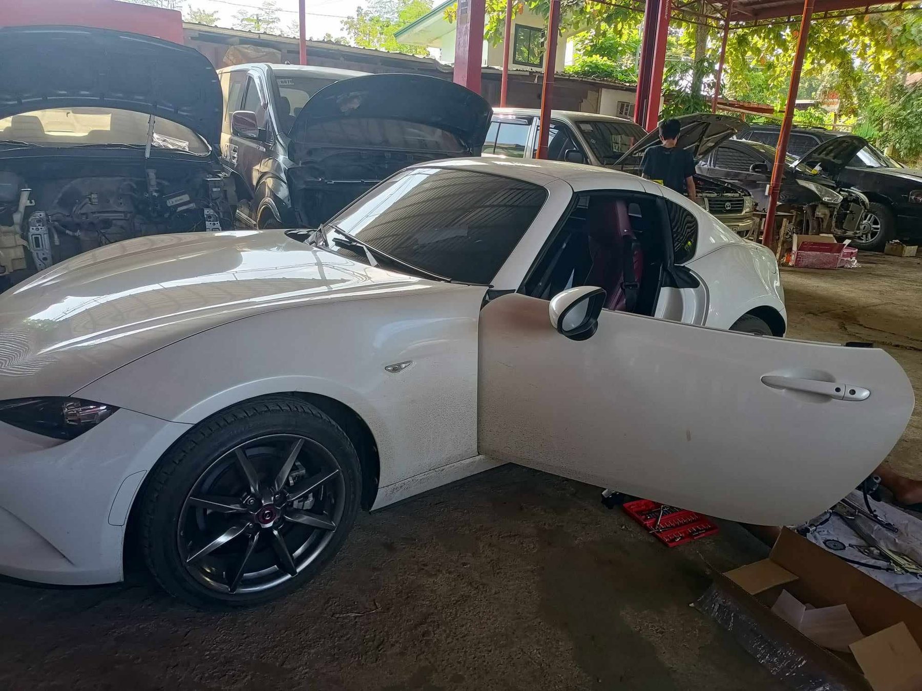 Technician working under the hood at BDJ Motors